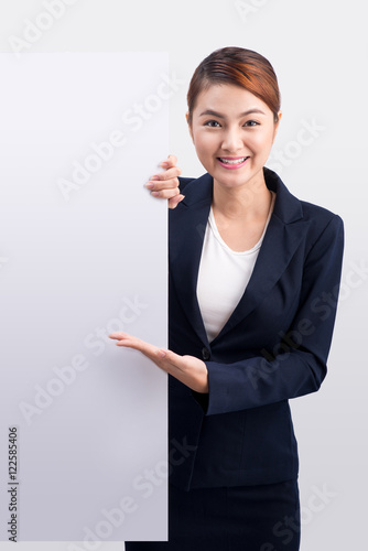 Young attractive asian woman showing a white board