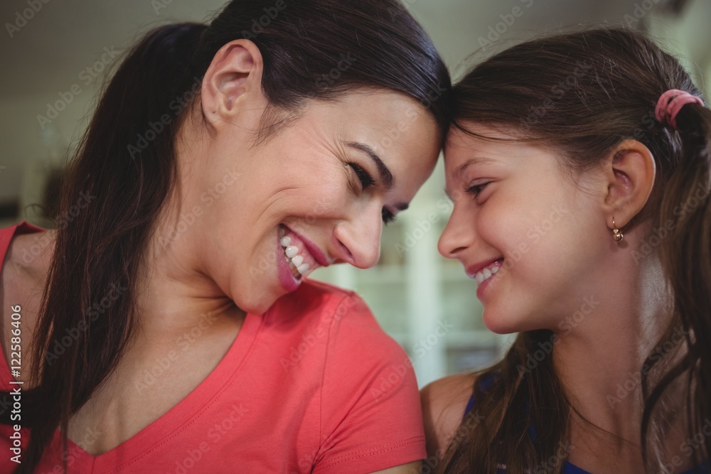 Mother and daughter looking face to face and smiling Mother and daughter looking face to face and smiling
