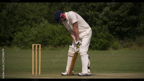 Batman strikes cricket ball cleanly.