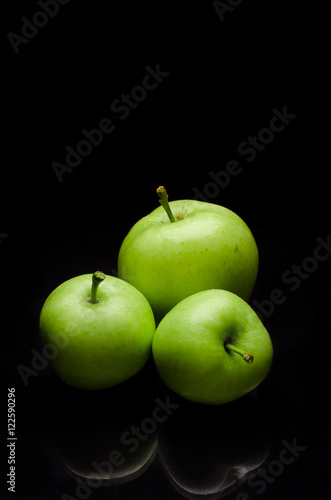 Green apples with black background