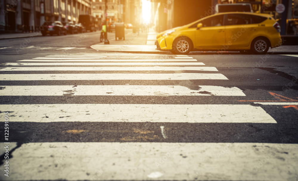 Focus on pedestrian lines in New york, with yellow cab in the ba Focus on pedestrian lines in New york, with yellow cab in the ba