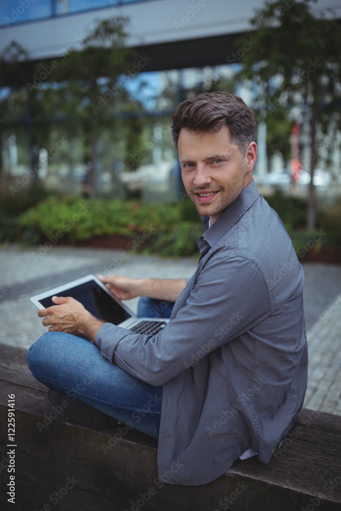 Fototapeta premium Portrait of handsome business executive using laptop