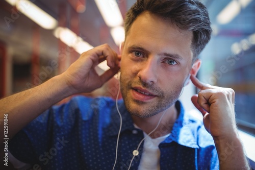 Portrait of handsome man listening music