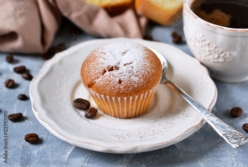 Vanilla muffins with fresh coffee for breakfast on a concrete background