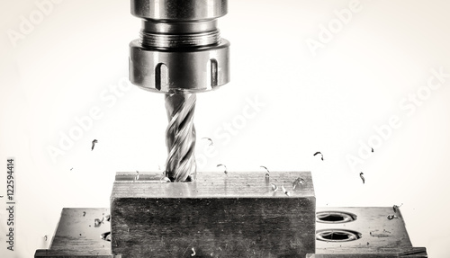 cnc milling machine - spindle with cutter, flying metal splinter photo