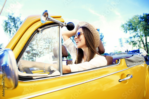 Fotografía Portrait of Young girl driving cabriolet at sunset