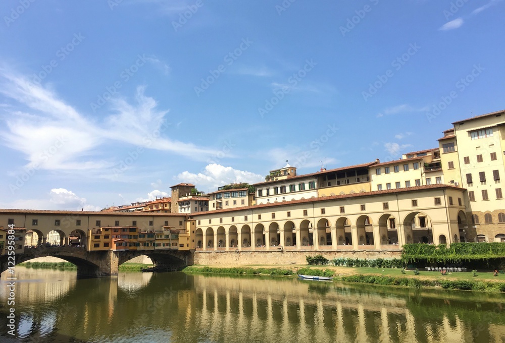 Florence, Italia - July 25th : view of the famous Ponte  Vecchio in Florence during summer with boats on the river. 