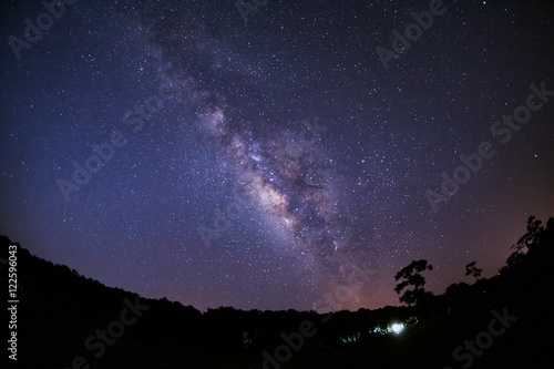 Milky Way Galaxy and Silhouette of Tree with cloud.Long exposure