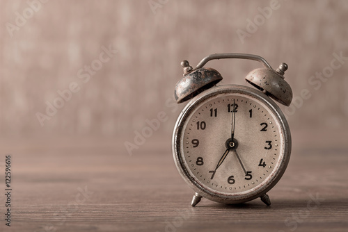 Vintage, old alarm clock on wooden