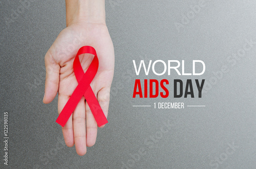 Canvas Print Female hands holding red ribbon HIV, AIDS awareness ribbon