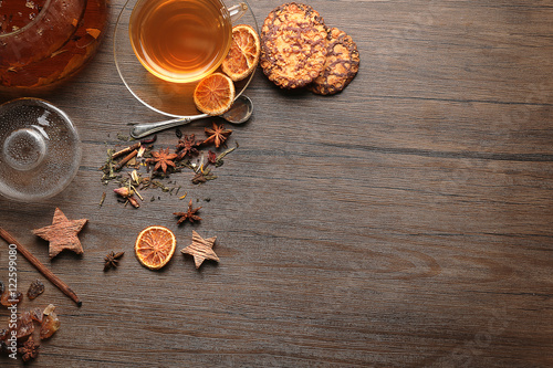 Ingredients for tea drinking on wooden background, flat lay