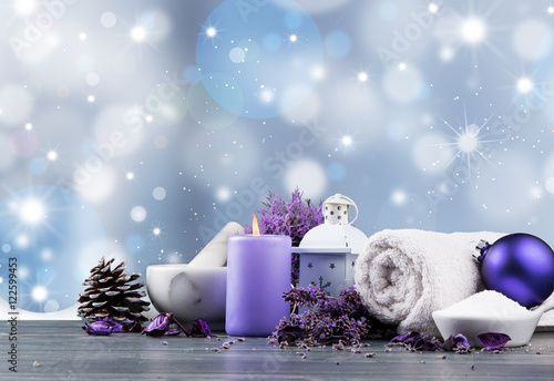 spa massage setting, lavender product, oil and christmas decoration on wooden background, Christmas wellness concept