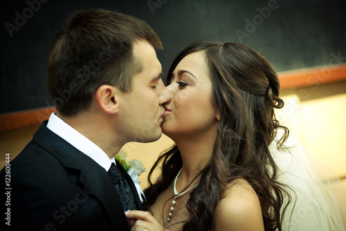 Groom kisses tender bride 