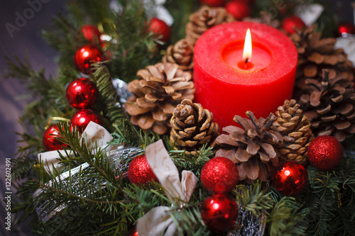 Decorated Christmas wreath with a candle close-up