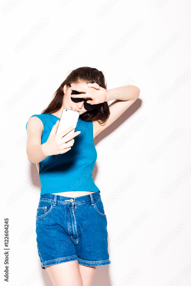 young attractive girl taking selfie photo portrait with mobile phone or camera wearing sunglasses young attractive girl taking selfie photo portrait with mobile phone or camera wearing sunglasses