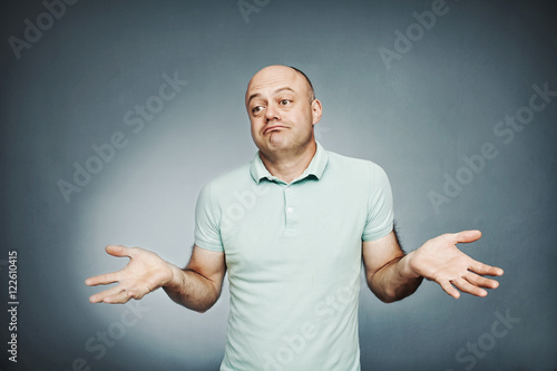 Closeup portrait middle-aged man shrugging shoulders who cares s