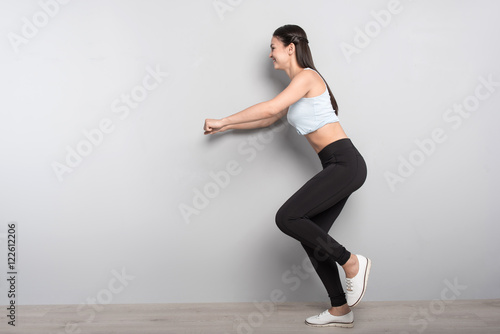 Positive woman doing sport exercises