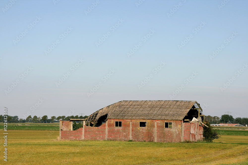 Fototapeta premium Old barn on a field.