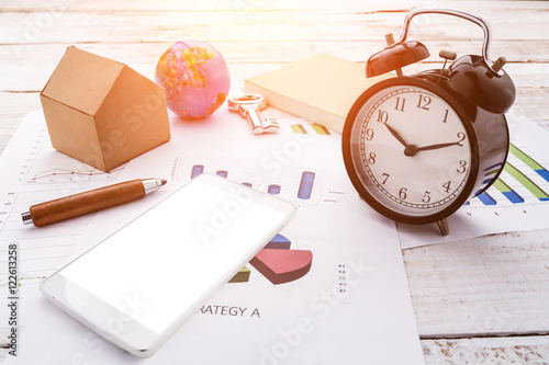 alarm clock with business supplies on table.jpg