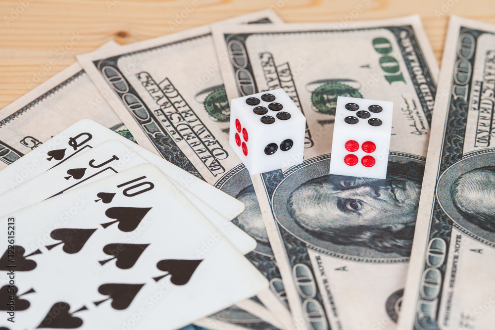 Two dices on wood table with US dollar Two dices on wood table with US dollar