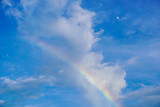 rainbow on blue sky background and the moon