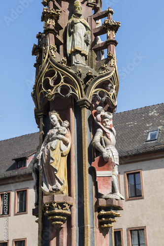 Fischbrunnen auf dem Münsterplatz in Freiburg im Breisgau (hl. Gregorius, hl. Maria mit Kind, hl. Leopold), Deutschland photo