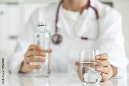 Woman doctor with drinking water