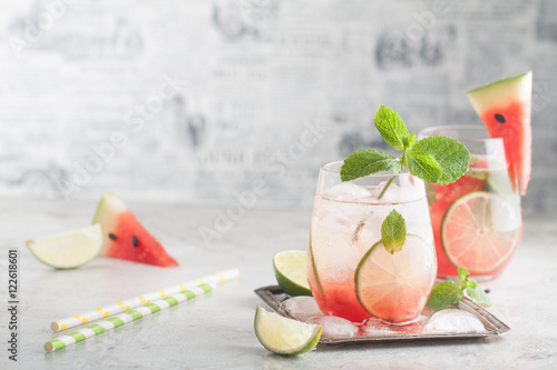 Fresh watermelon lemonade with lime, ice and mint for the summer party on the metal tray