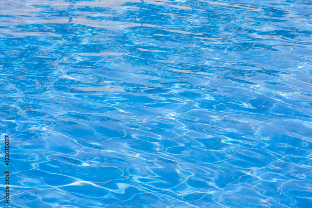 Blue swimming pool rippled water.