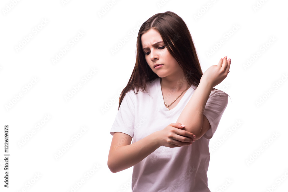 Acute pain in a woman elbow. Female is holding hand to spot of elbow pain indicating location of the pain. Isolation on a white background. Acute pain in a woman elbow. Female is holding hand to spot of elbow pain indicating location of the pain. Isolation on a white background.