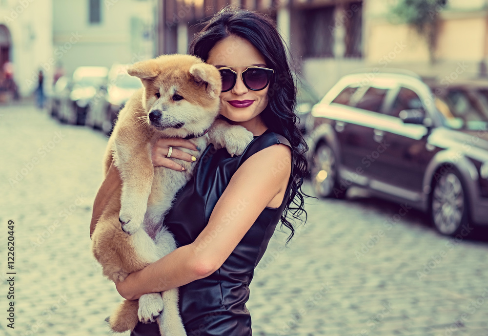 Female holding a dog puppy. Female holding a dog puppy.