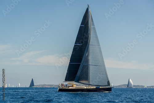Luxury big sailing yacht with black sails.