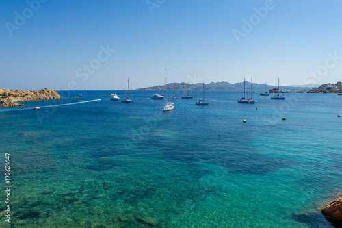 Mediterranean bay with turquoise water and sailing boat anchorage.
