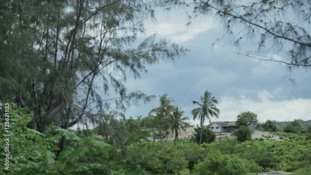 African forest and houses next to beach, Mozambique, wide shot, LR Pan African forest and houses next to beach, Mozambique, wide shot, LR Pan