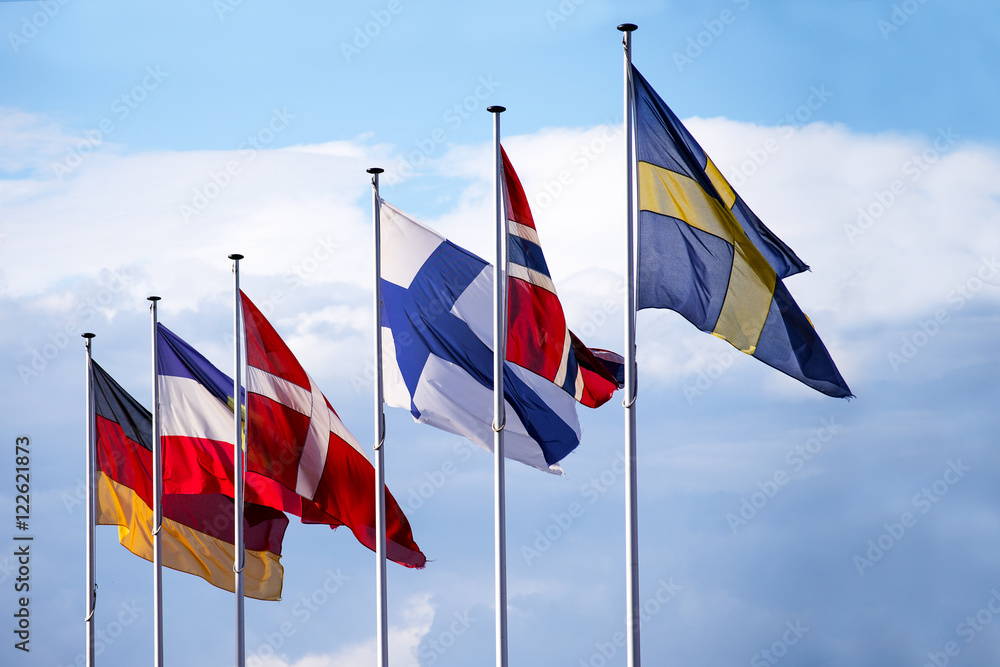 flags of the nordic european countries against the blue sky with clouds flags of the nordic european countries against the blue sky with clouds