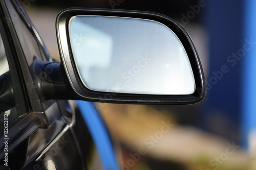 blank car rearview mirror with copy space, blurred background © Maren Winter