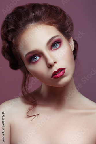 Beauty portrait of beautiful girl with languid gothic make-up on a violet background