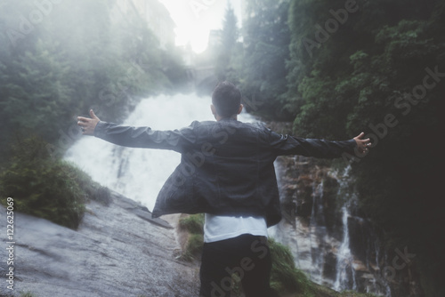Man by the waterfall
