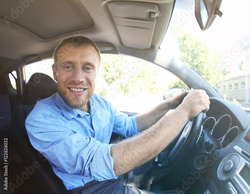 Handsome man driving car