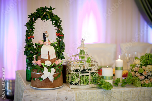 Wedding bread stands on the table decorated with white candles a