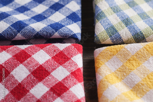 Colored checkered napkins on wooden table