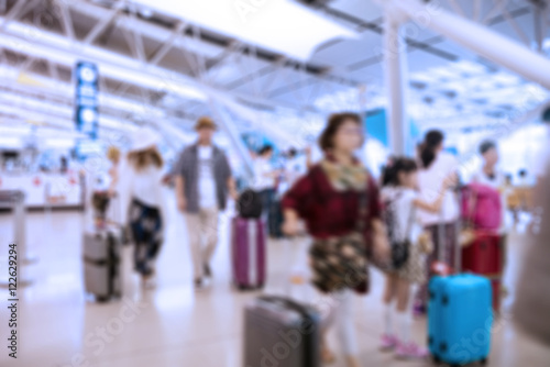 People traveling at airport terminal in blurred motion with retro color effected