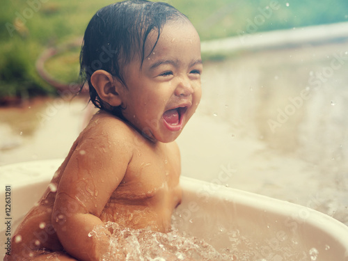 Asian Baby Girl have fun while taking a shower.