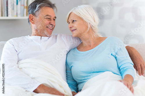 Senior couple lying in bed together 
