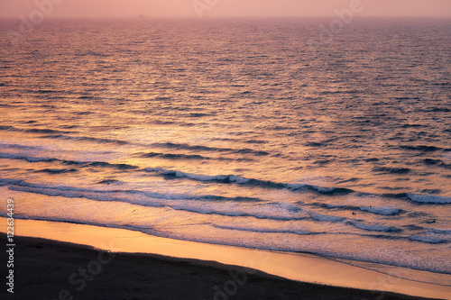 beach with waves at sunset