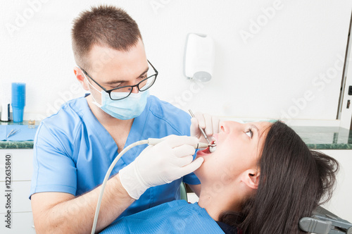 Girl sitting in dentist chair having a consultation from doctor
