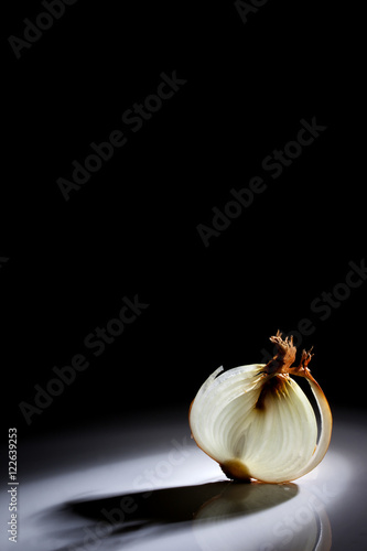 Slice of onion on a black background with a beautiful back light.