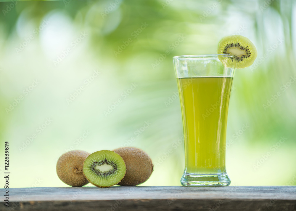 kiwi juice and kiwi on wooden table outdoor