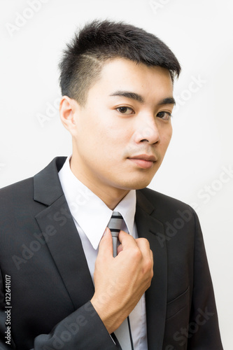 Portrait of asian businessman in black suit