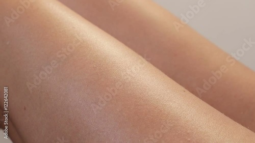 Slow motion preventing dry skin on female body close-up 1920X1080 HD footage - Treatment on woman legs with hydrating cream slow-mo anti-aging 1080p FullHD video 